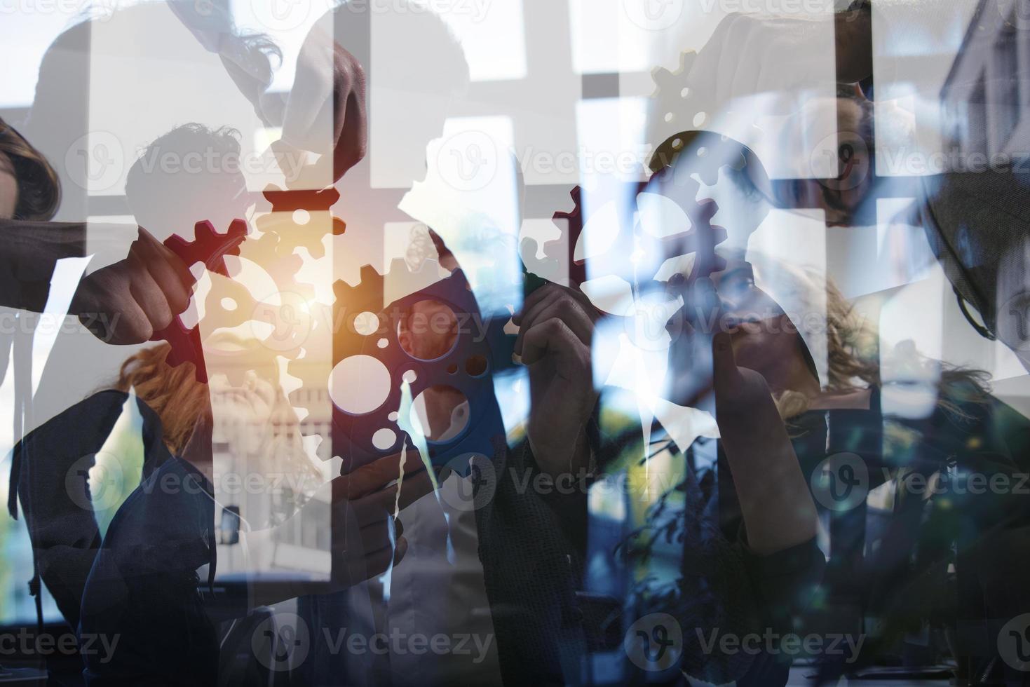 Business team connect pieces of gears. Teamwork, partnership and integration concept. double exposure photo