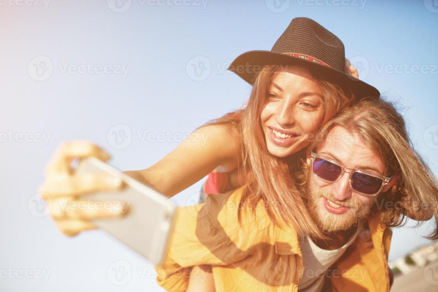 Happy group of friend makes a selfie with a mobile phone. photo