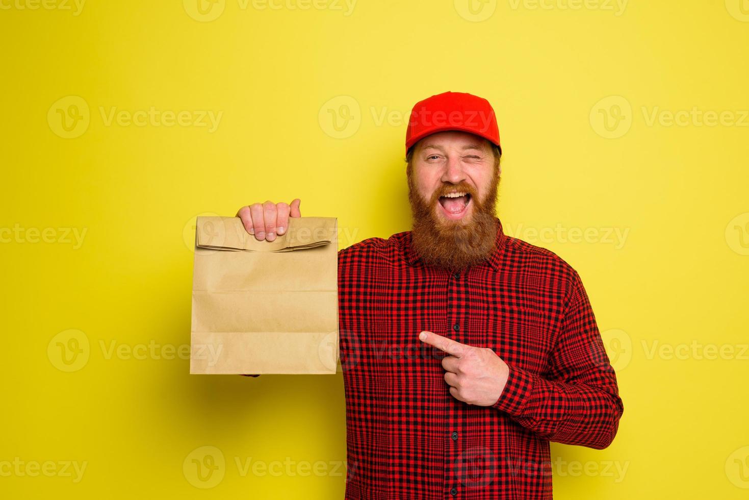 Delivery man with hat and beard has an happy expression photo