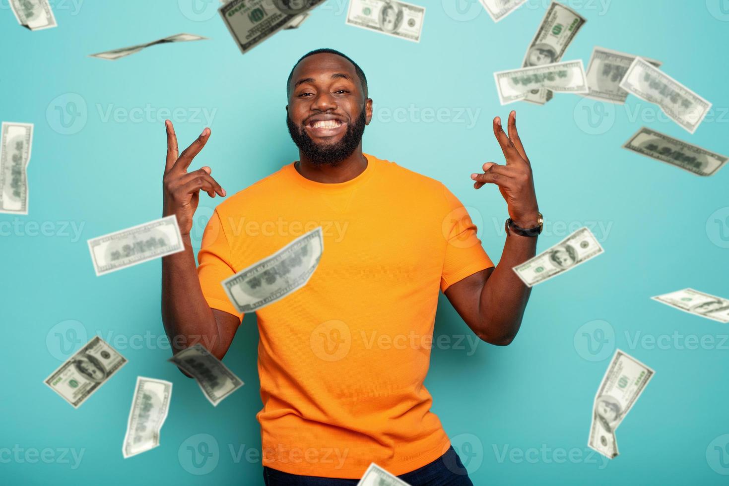 Boy wins money. Amazed and surprised expression face. Light blue background. photo