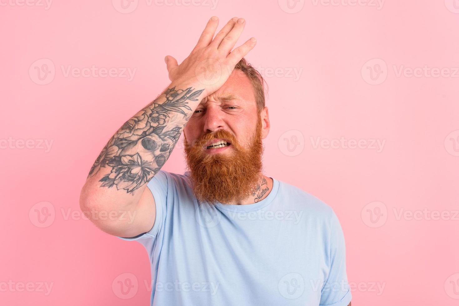 Delusion man with beard and light blue t-shirt photo