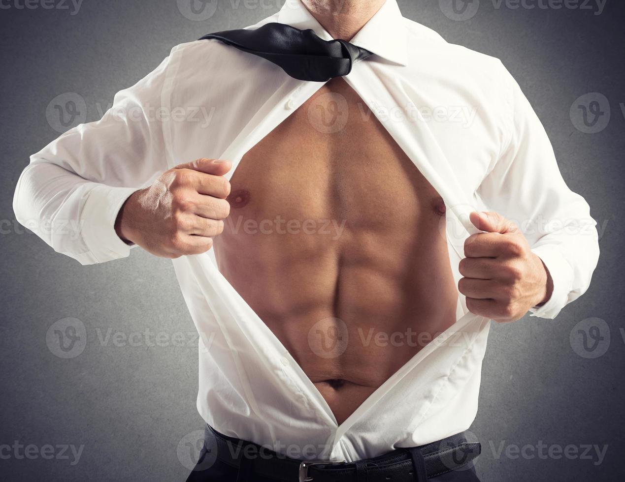 Businessman acts like a superhero. concept of bravery, determination and success photo