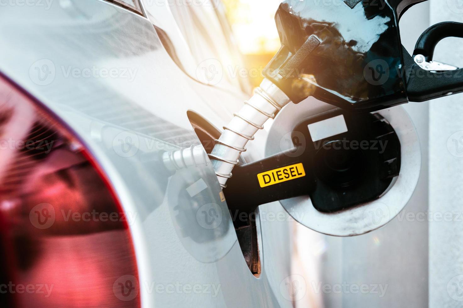 Fuel pump fill a tank of a car in a station photo