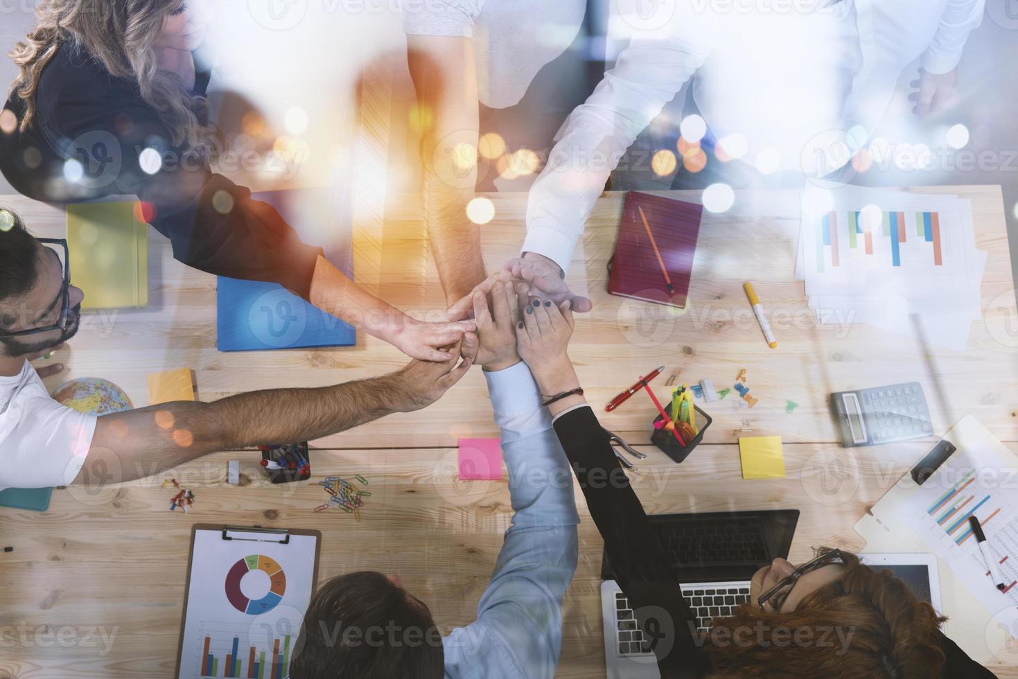 Business people putting their hands together. Concept of integration, teamwork and partnership. Double exposure photo