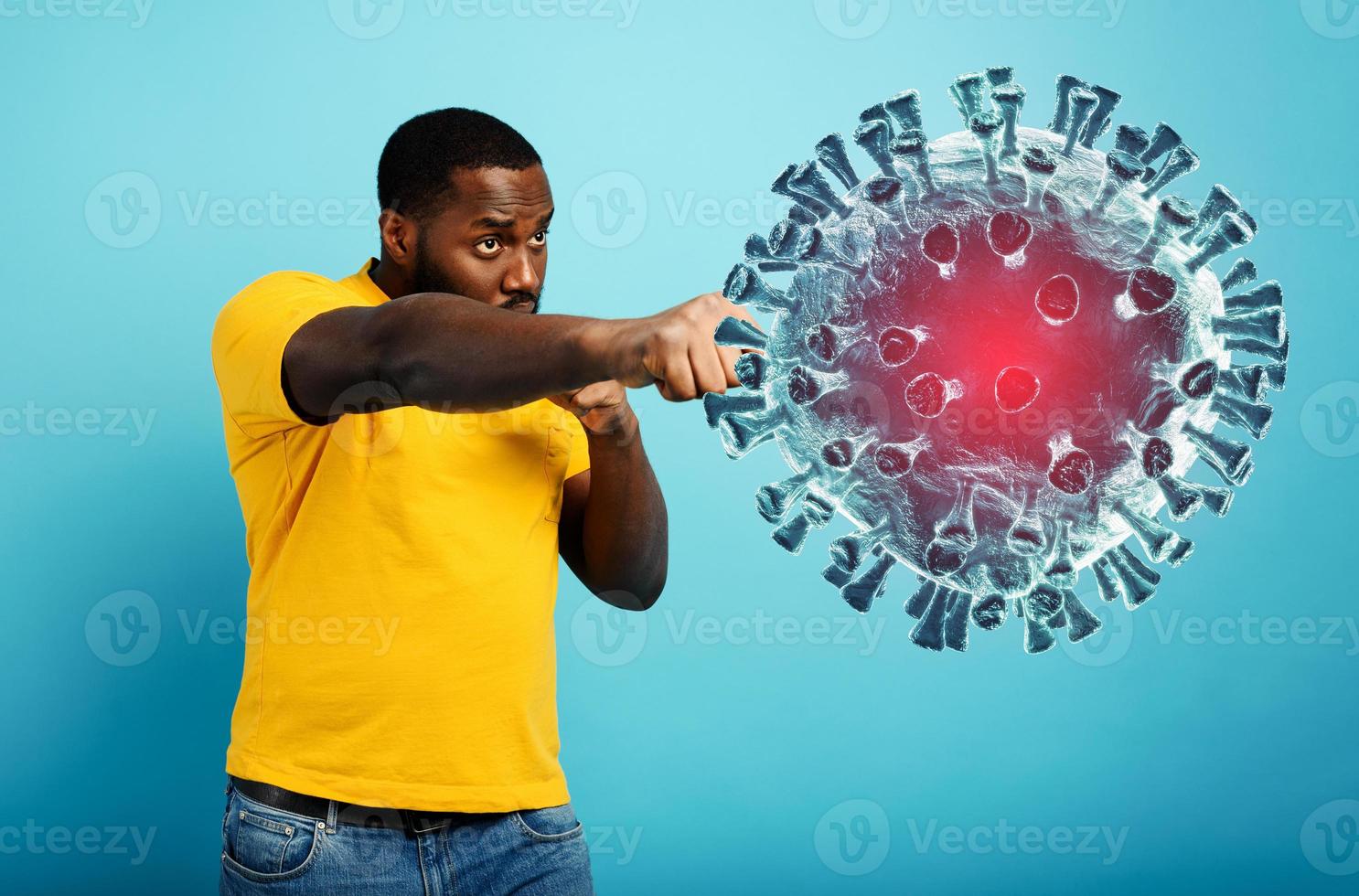 Man attacks with a punch the coronavirus. Blue background photo