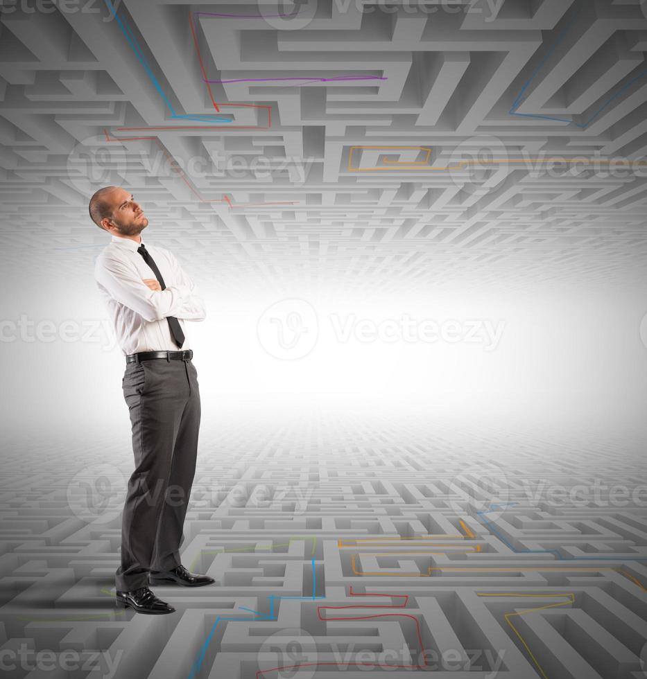 Confused business man seeks a solution to the labyrinth photo