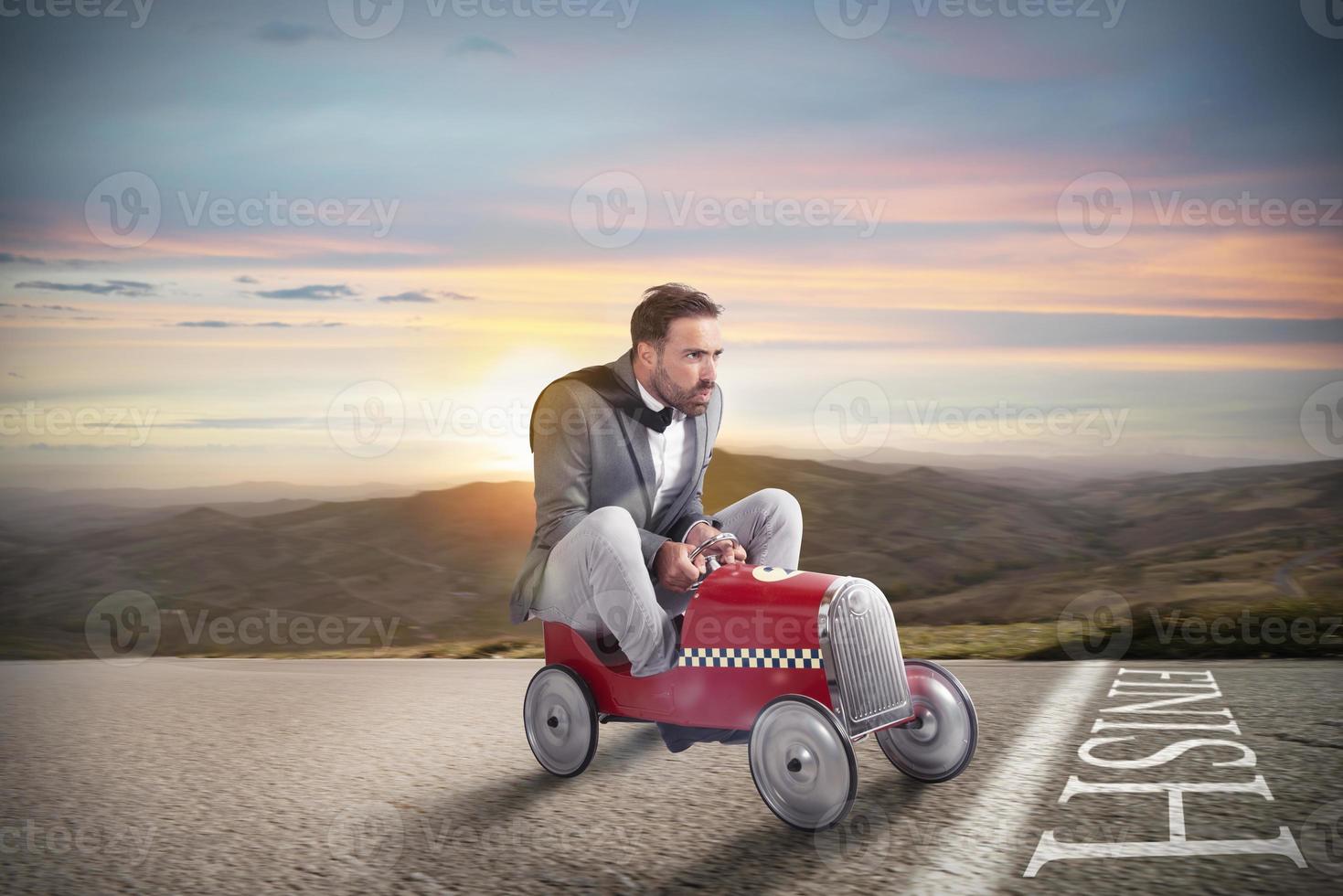 Successful businessman on the finishing line with his car photo