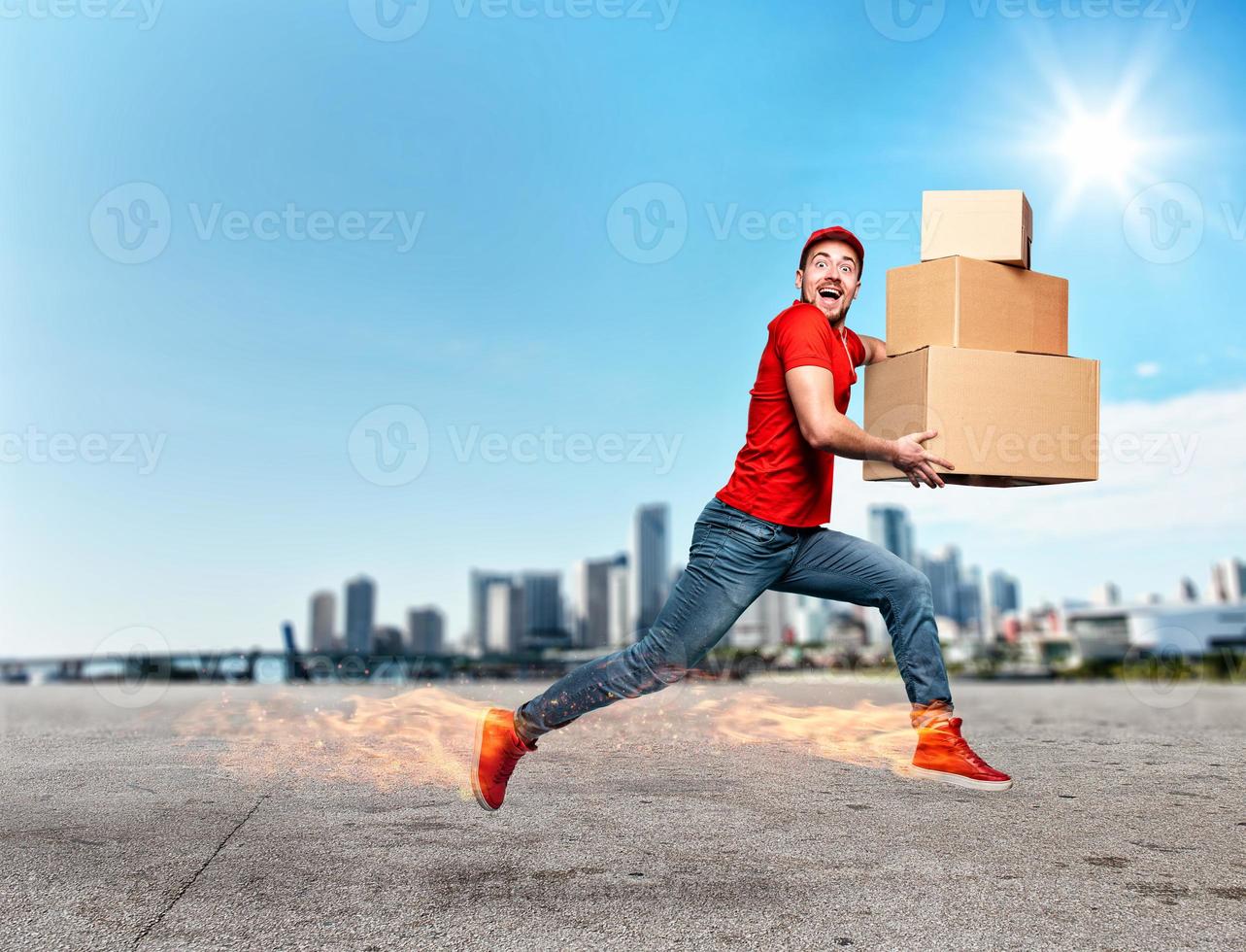 Courier with fiery feet has a lot of boxes to delivery. Emotional expression. photo