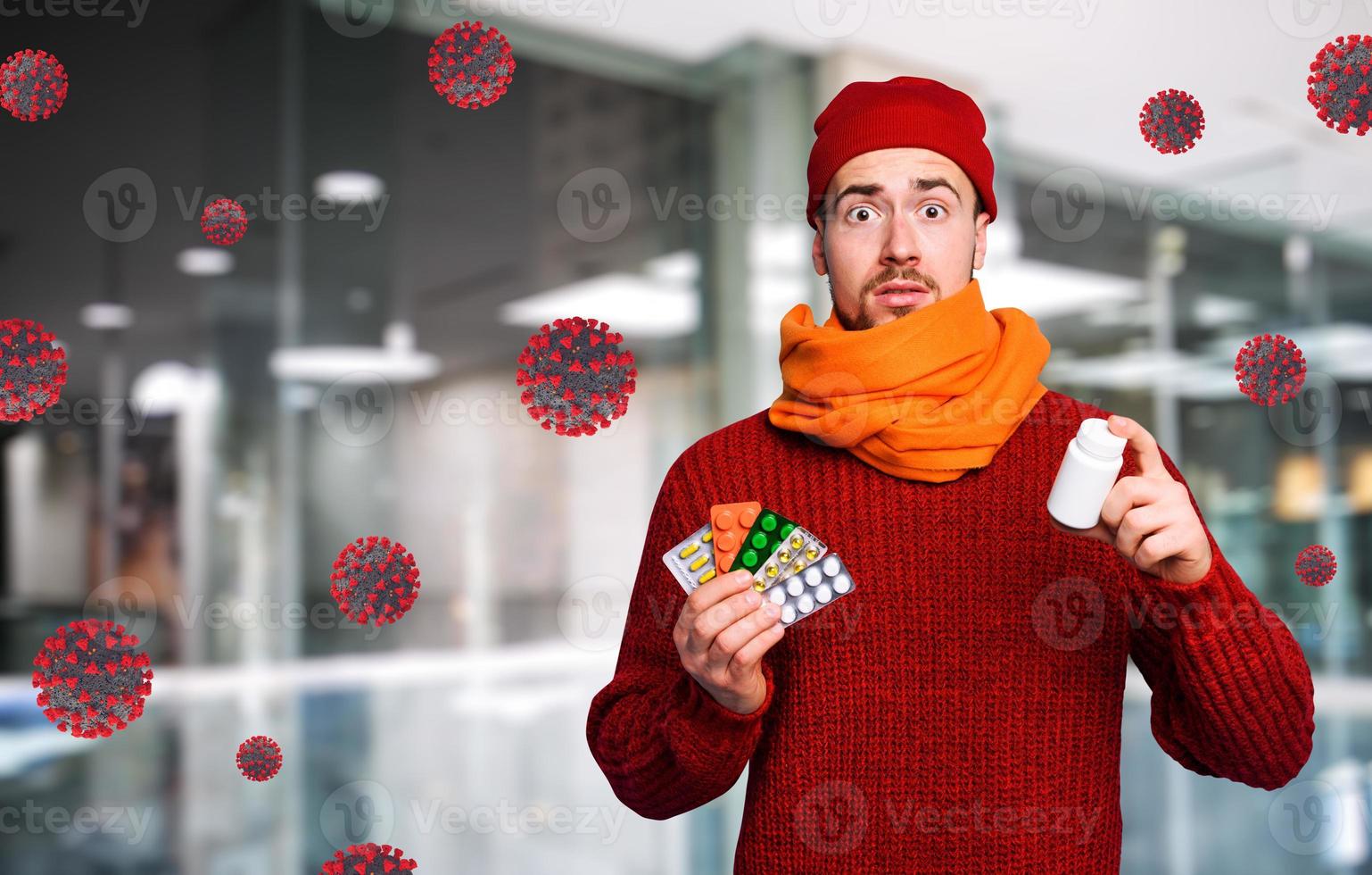 Boy caught a cold and uses pills to heal. Studio on Cyan background photo