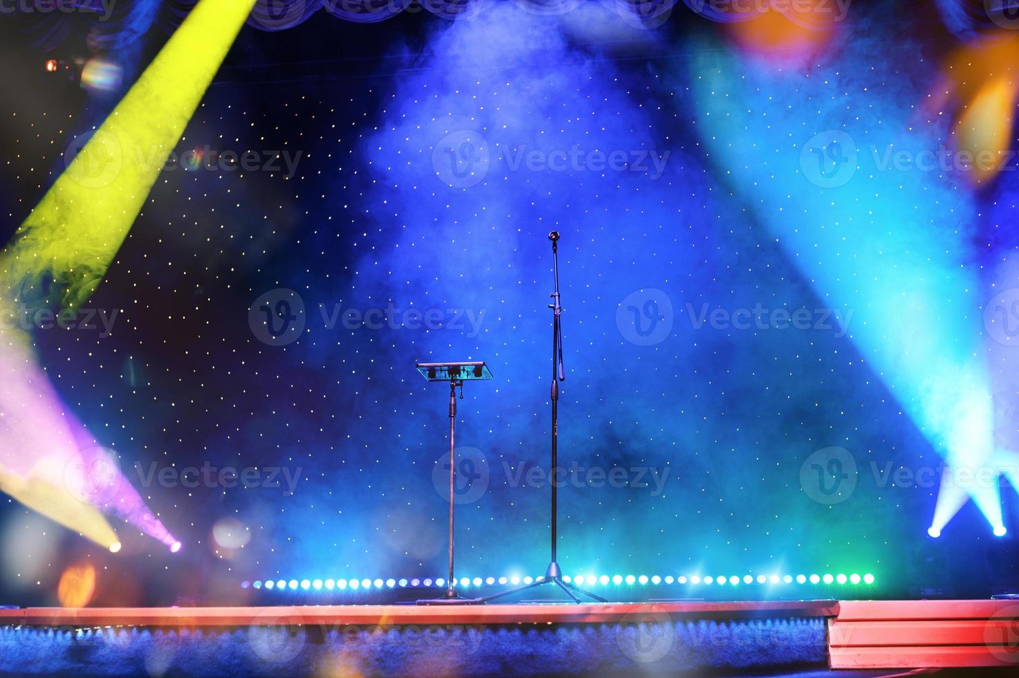 Elegant theatre show with colored spotlights and microphone photo