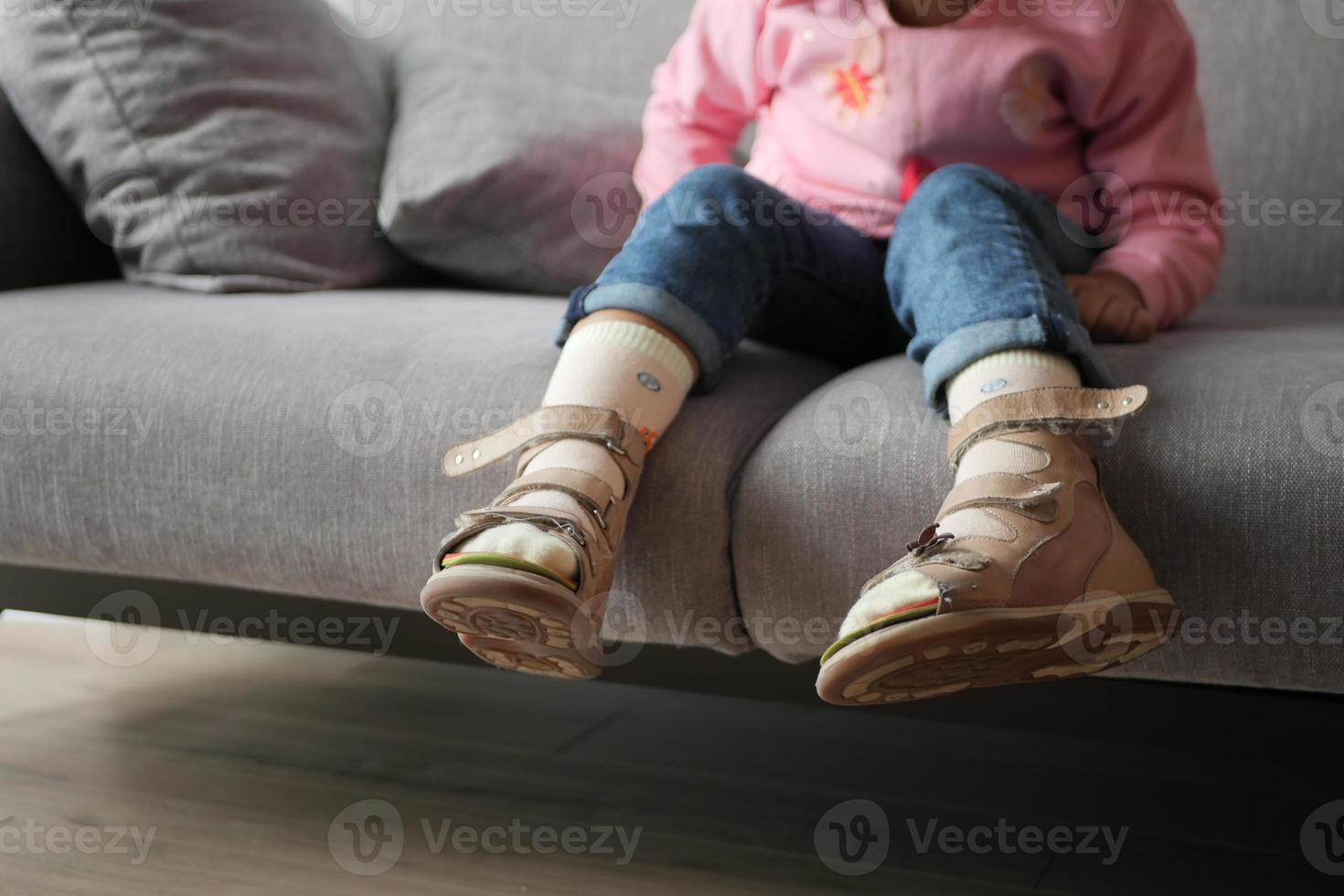 Child cerebral palsy disability, legs orthosis. photo