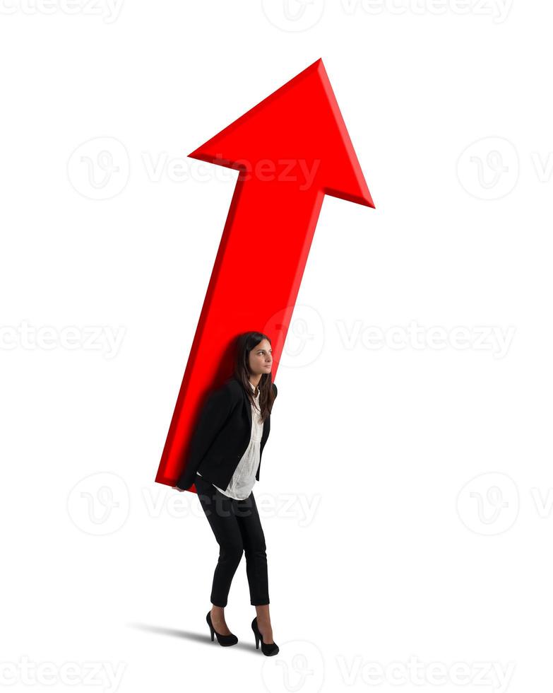 Businesswoman holds a big arrow. Concept of business growth and success photo