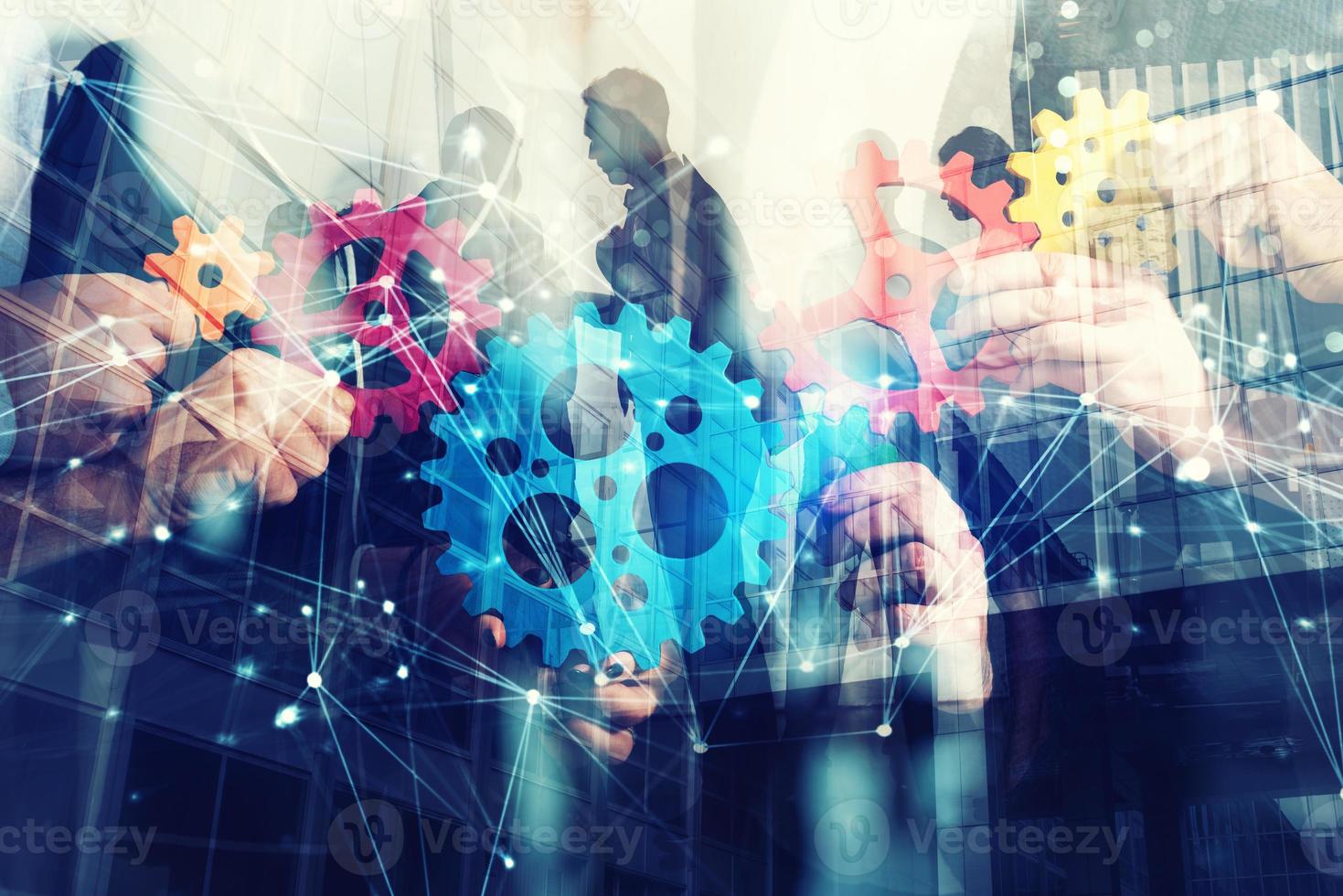 Working group of businessmen find the agreement by holding a piece of gear in hand. concept of teamwork and business partnership. double exposure photo