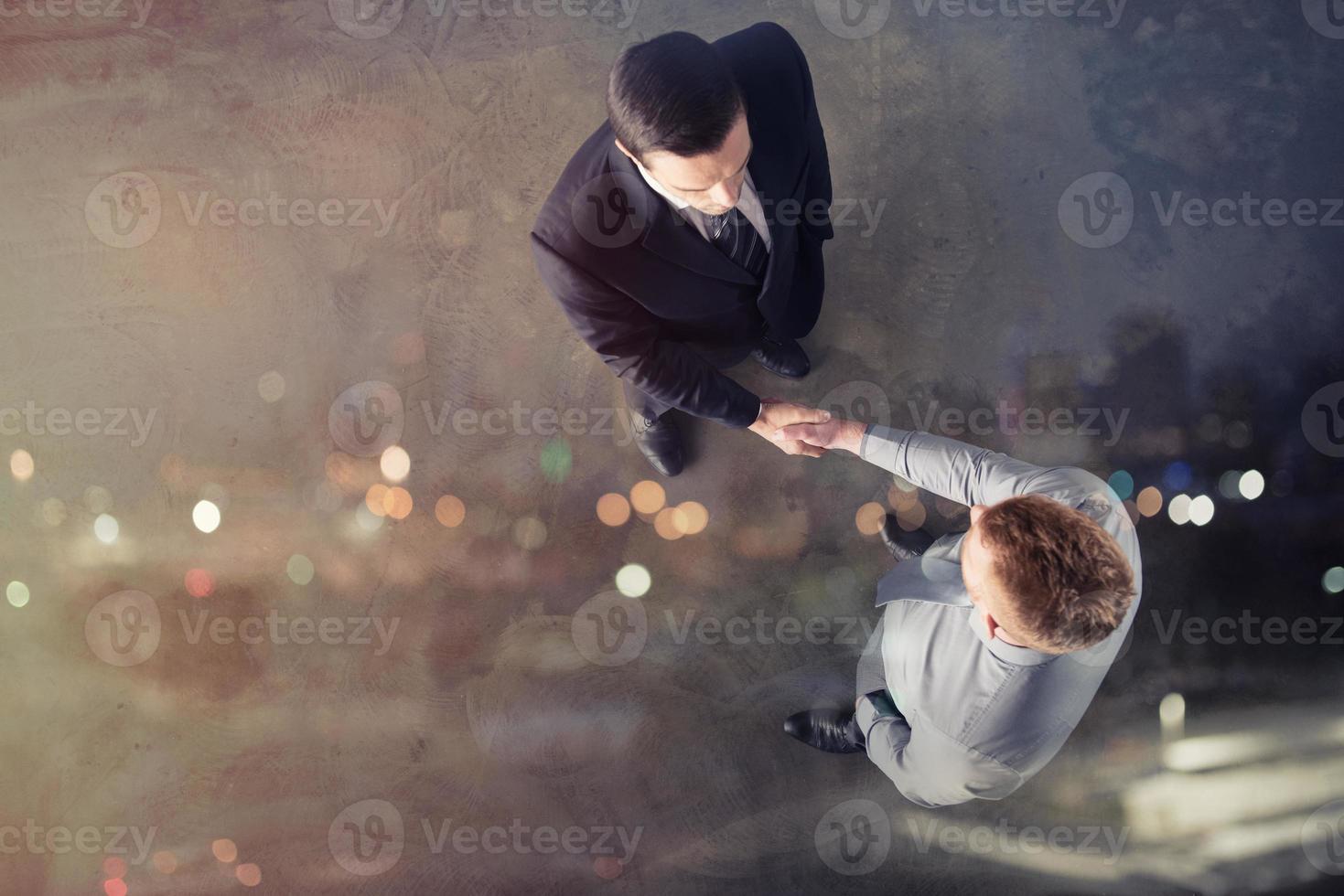 Handshaking business person in office. concept of teamwork and partnership photo