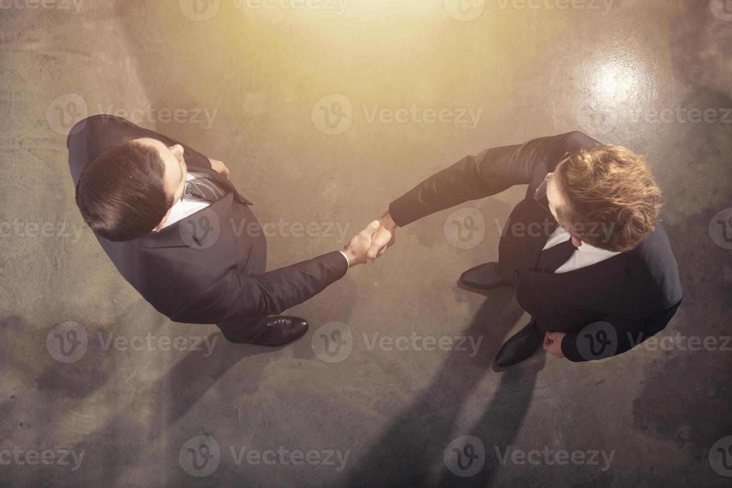 Handshaking business person in office. concept of teamwork and partnership. photo
