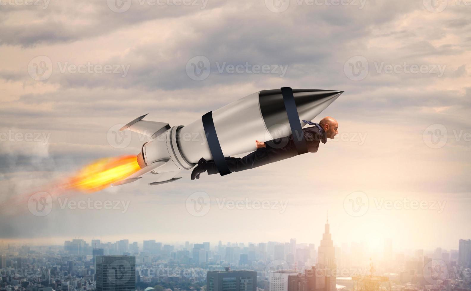 Businessman flies with a fast rocket. Concept of ambition and determination photo