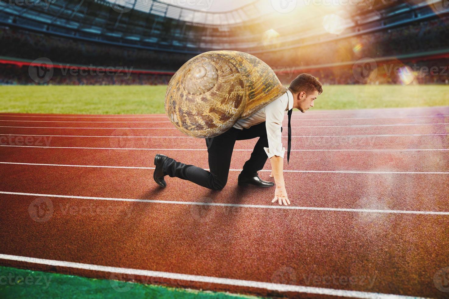 Businessman runs slow like a snail in a runner race photo