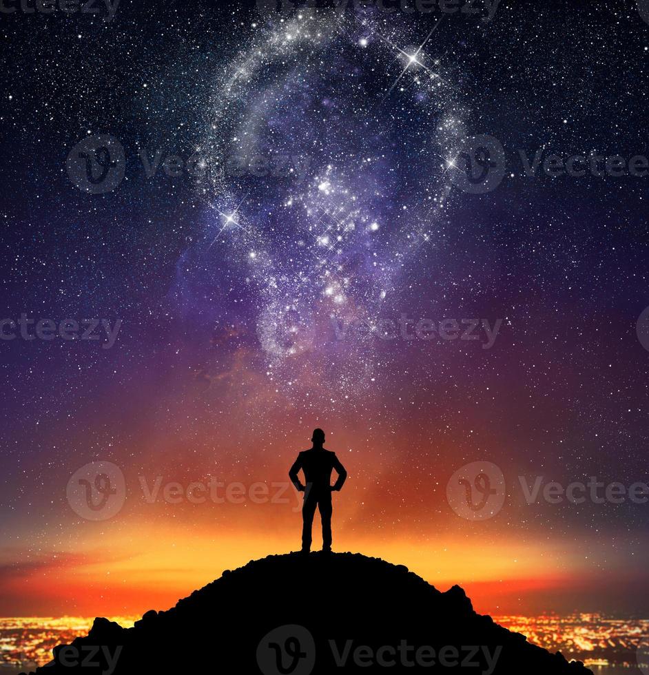 Businessman illuminated by a bright idea photo