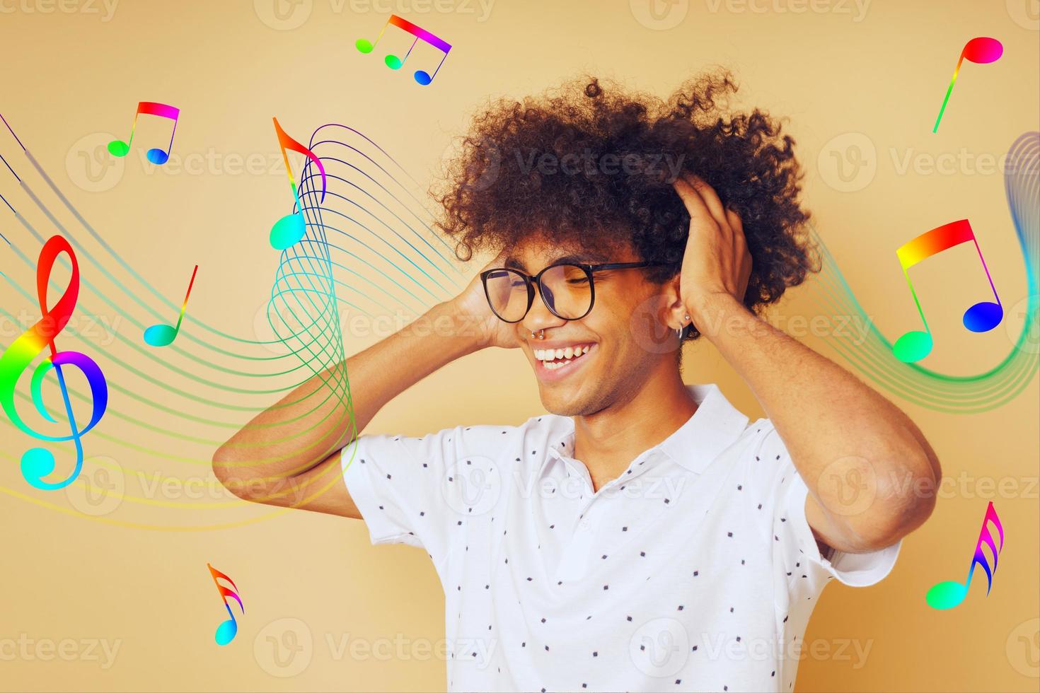 Happy afro man dances and listens to music photo