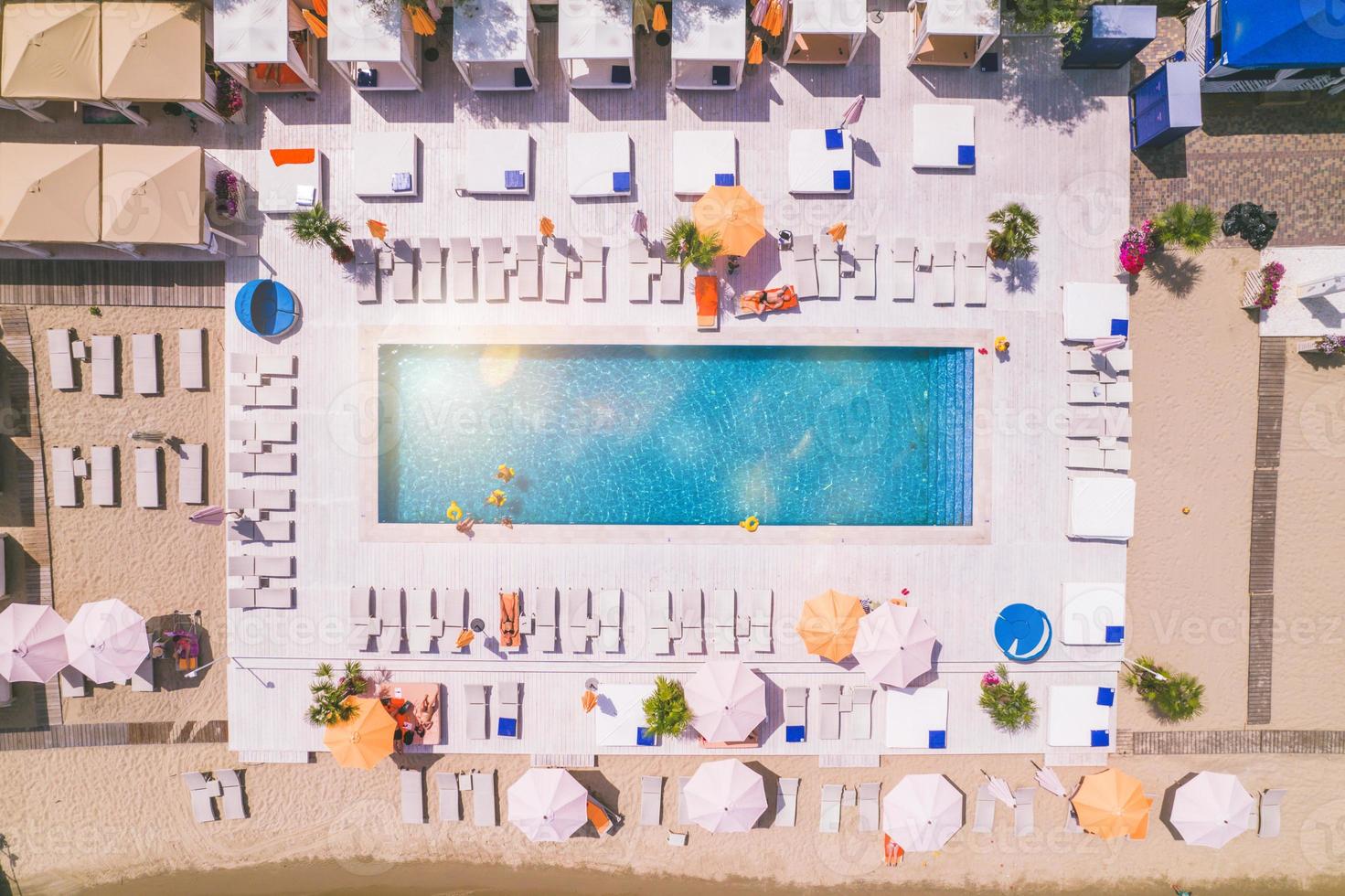 Drone view of people who relaxing in a swimming pool from photo