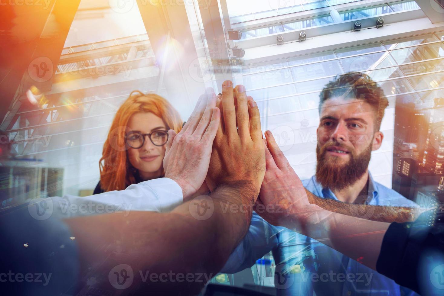 Business people putting their hands together as teamwork and partner photo