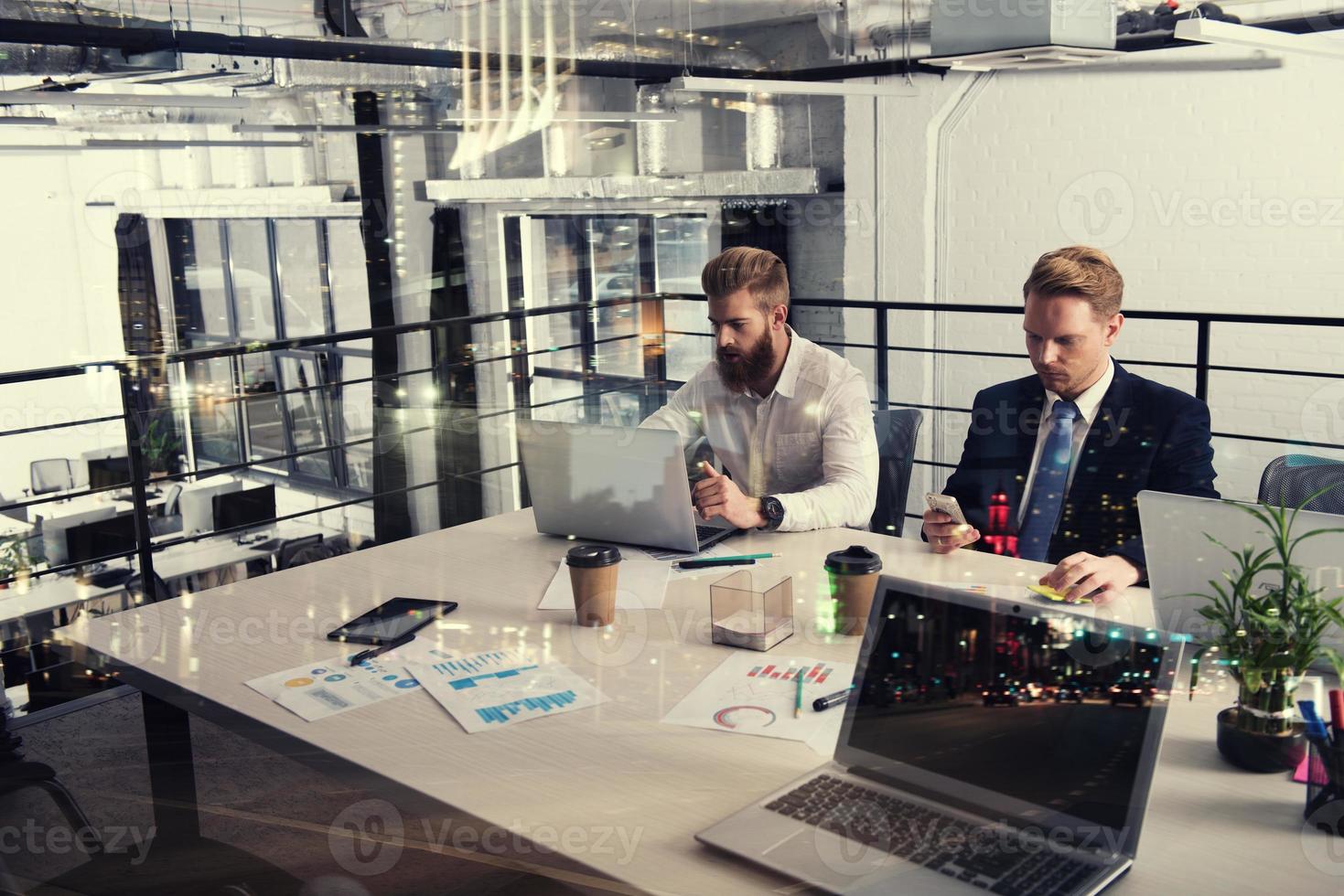 Business people that work together in office at the night. Concept of teamwork and partnership. double exposure photo