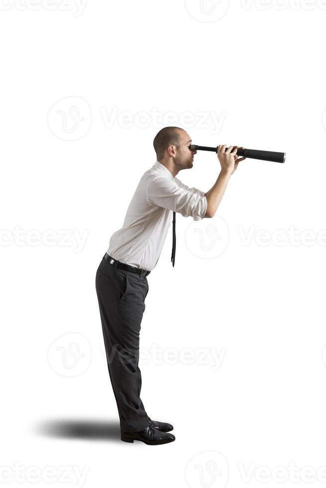 Businessman with telescope photo