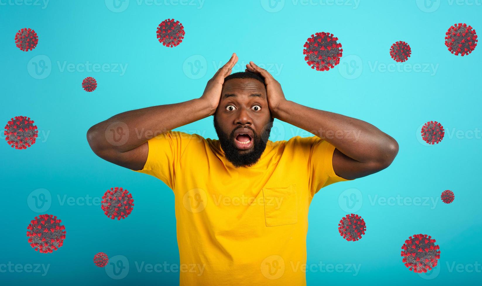 Fearful expression of a boy who is scared to catch the coronavirus. Cyan background. photo