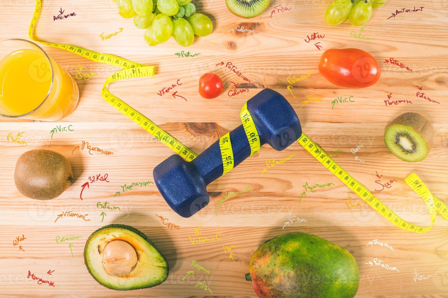 Fitness with dumbbell and genuine food with fresh fruit photo