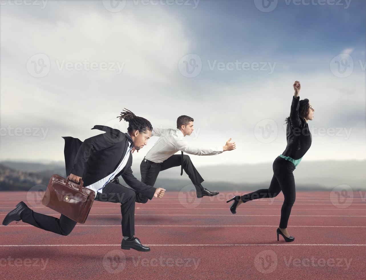 Businesswoman wins a run contest against the competitors. Concept of success photo
