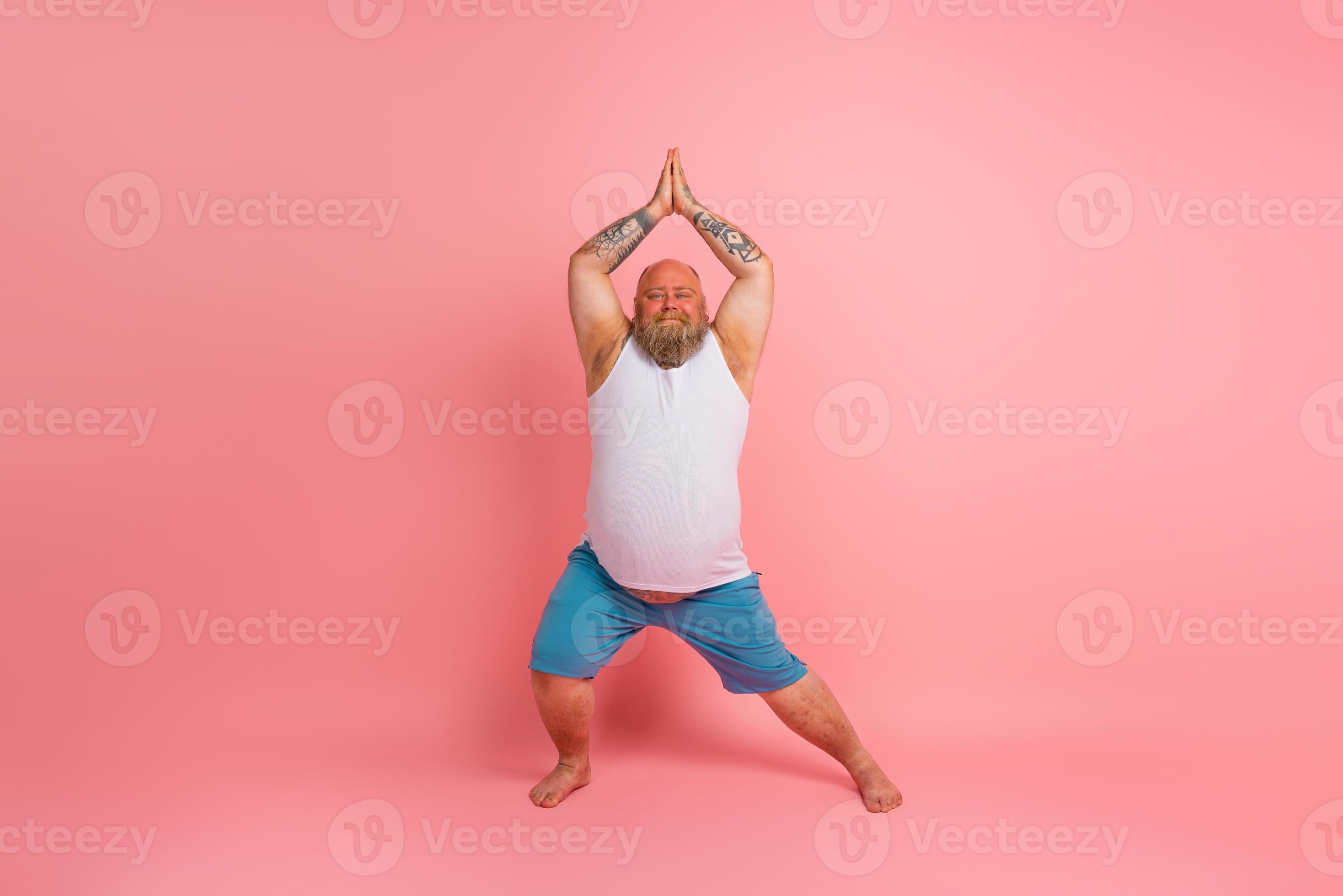 Funny man with beard in yoga position on studio pink background 20566262  Stock Photo at Vecteezy