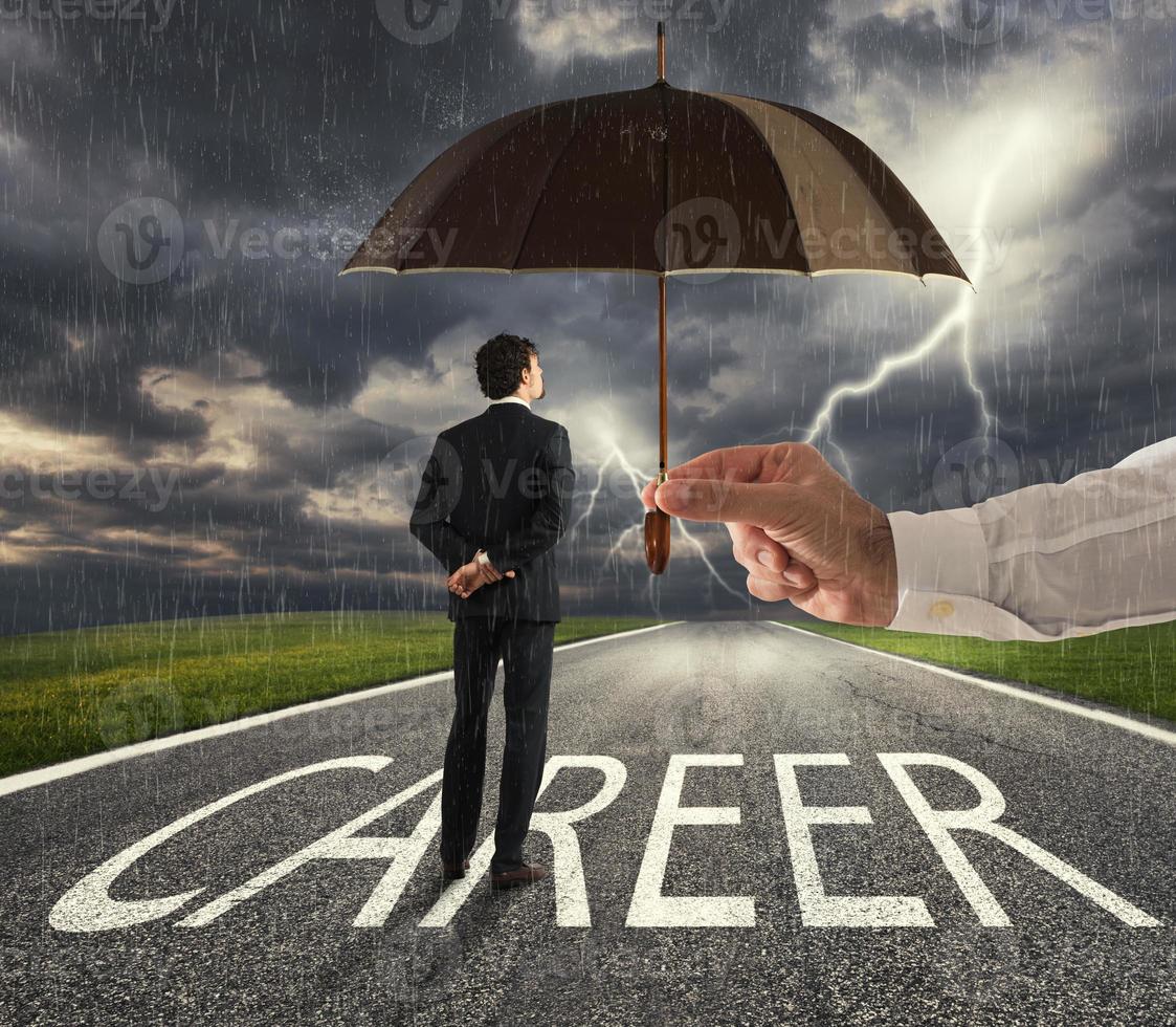 Businessman ready to start a difficult career way with a big help of an umbrella. concept of support and assistance photo