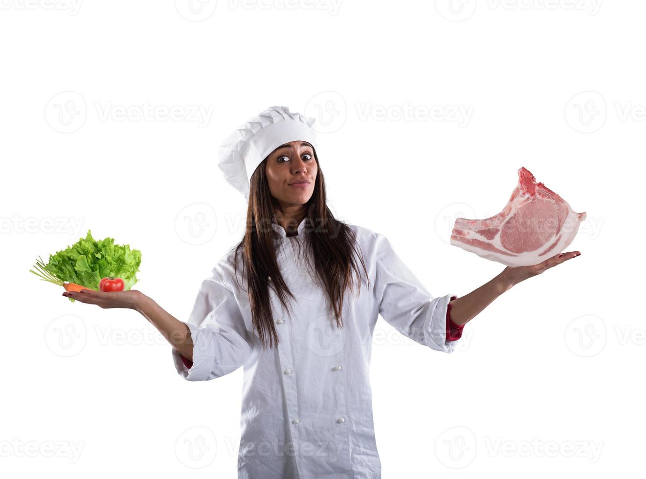Chef undecided between fresh salad or meat steak. concept of vegetarian photo