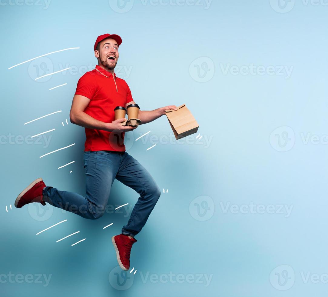 Courier runs fast to deliver quickly ordered breakfast. Cyan background photo