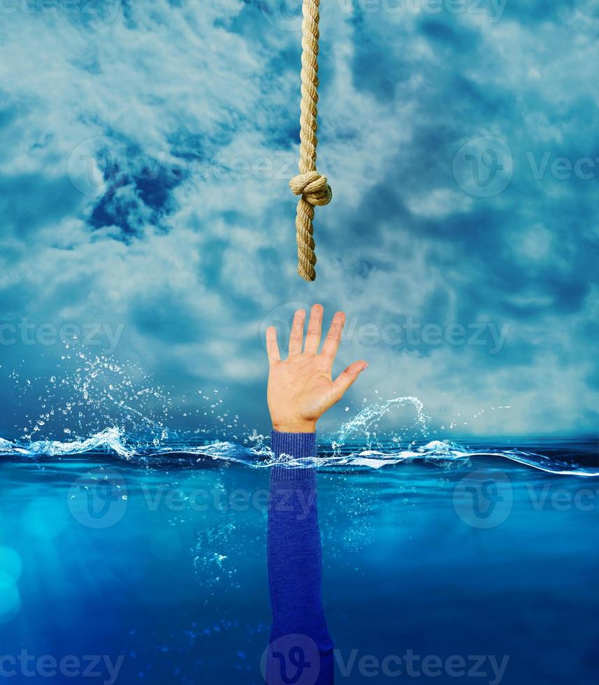Person is drowning and needs help. concept of crisis and problem photo