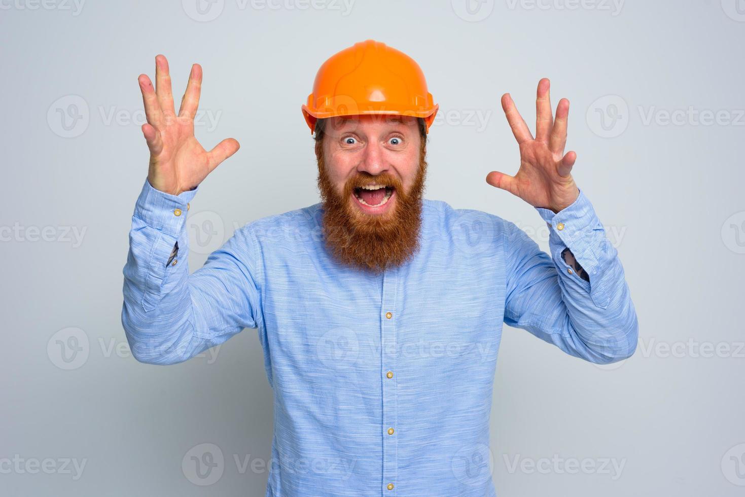 Isolated happy architect with beard and orange helmet photo