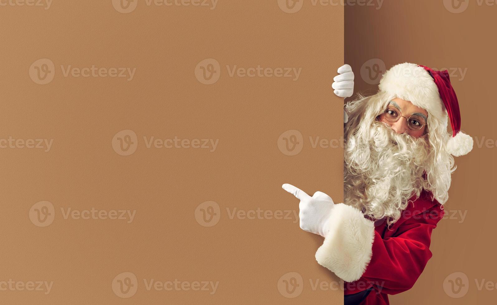 Santa claus indicates a blank space for your text photo