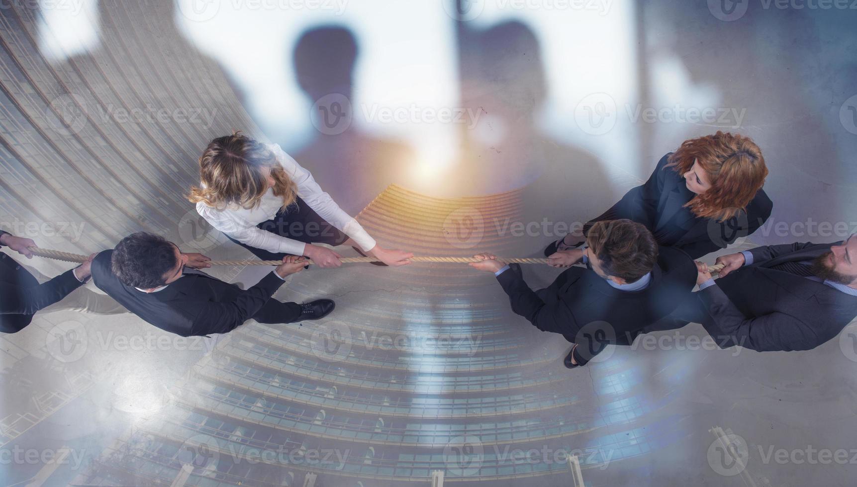 Rival business man and woman compete for the command by pulling the rope. double exposure photo