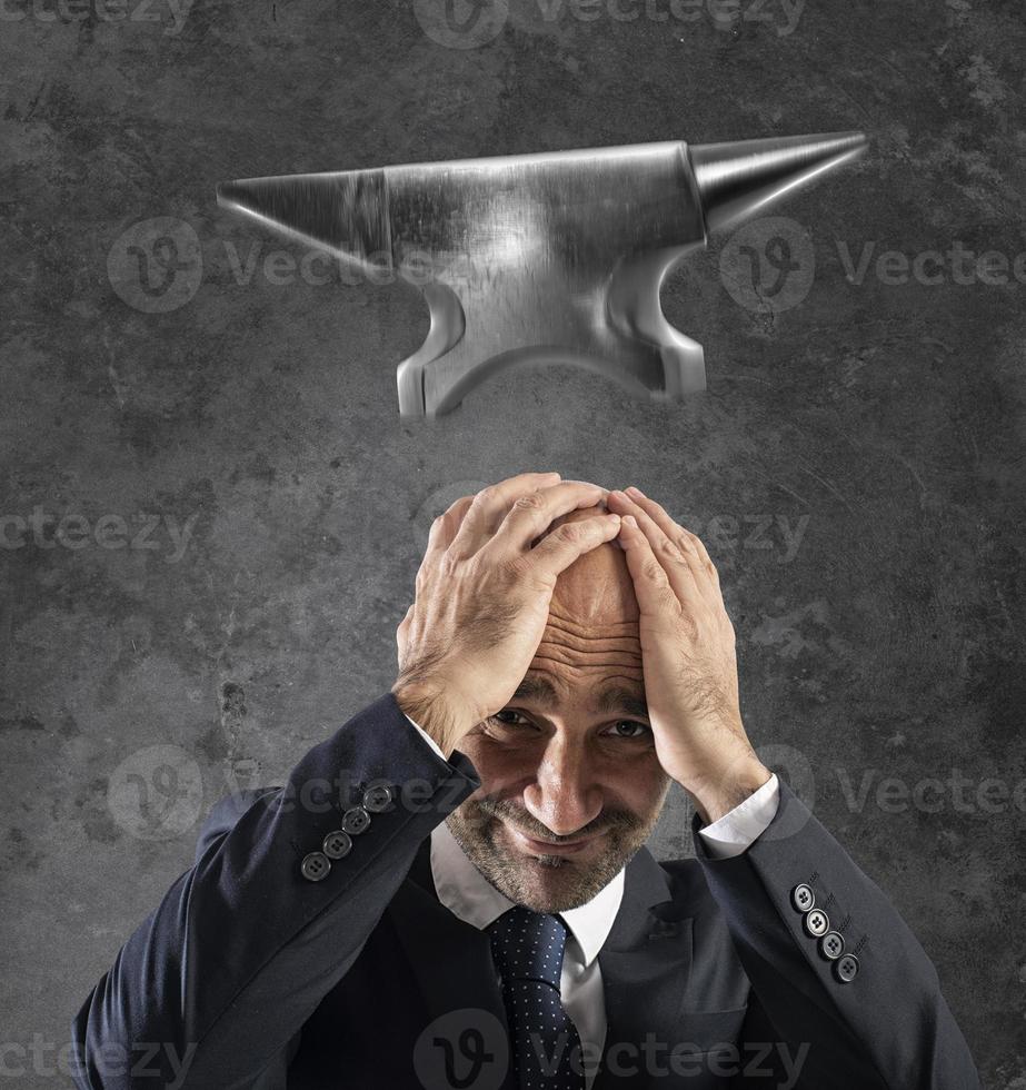 Difficult career in business with falling anvil photo