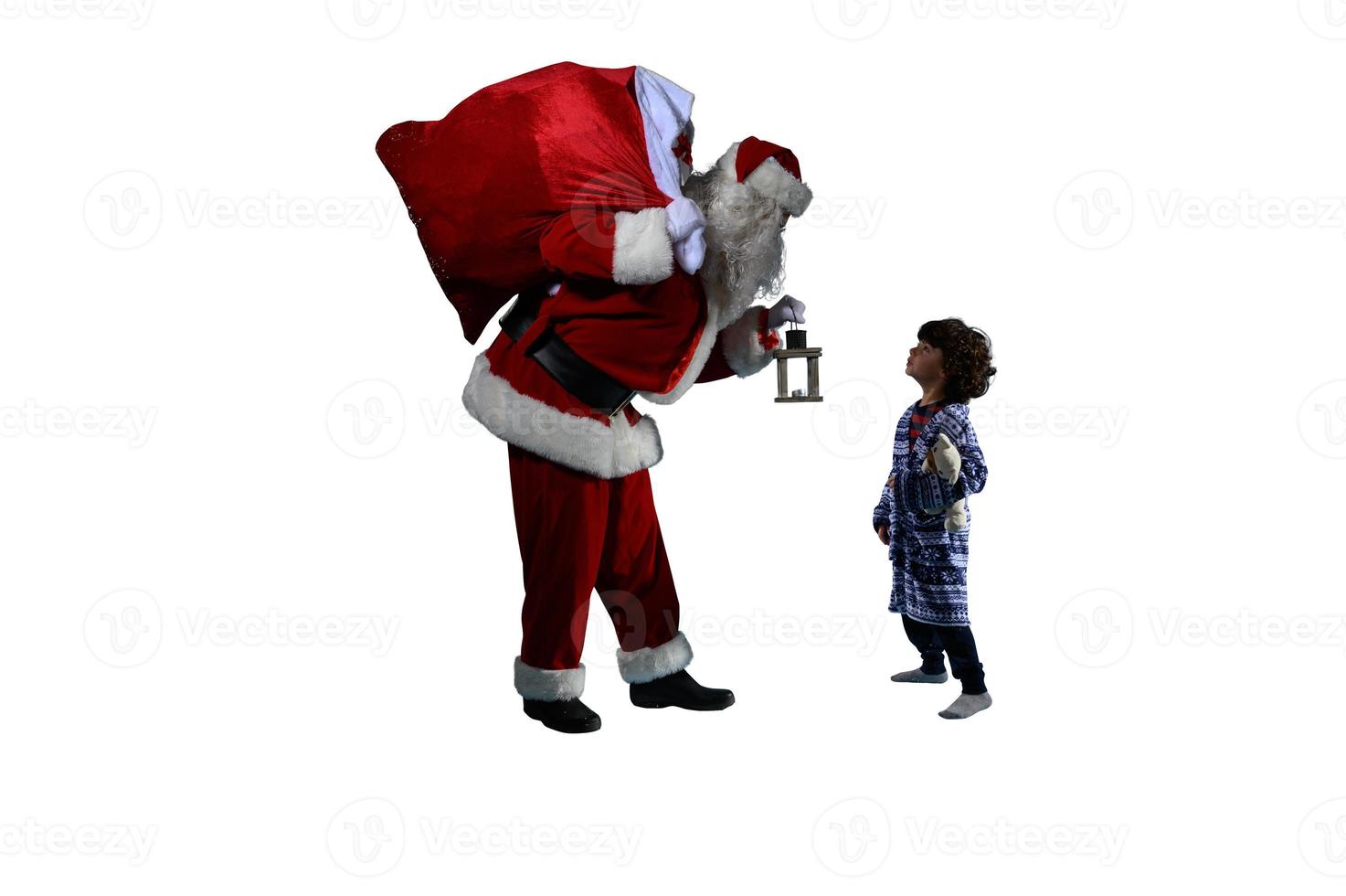 Santa claus is giving a present for christmas to a little boy photo
