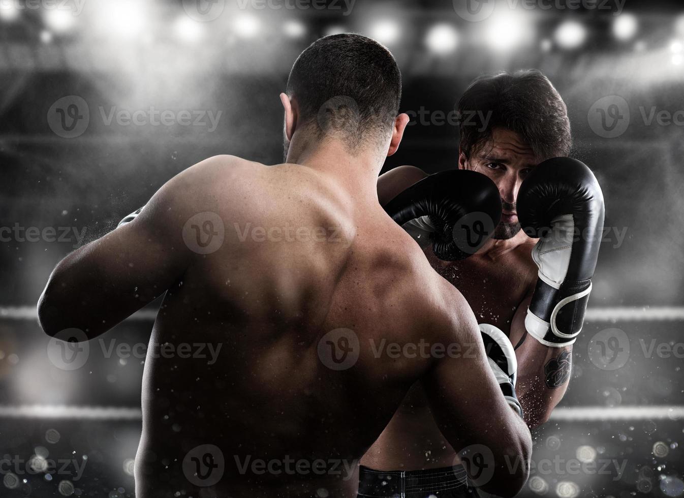 Boxer in a boxe competition beats his opponent photo