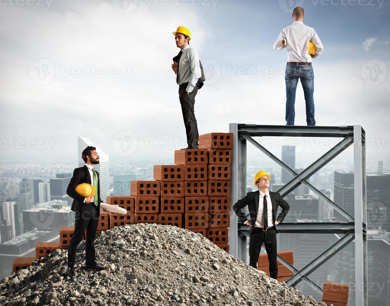 Businessmen work together to build a building photo