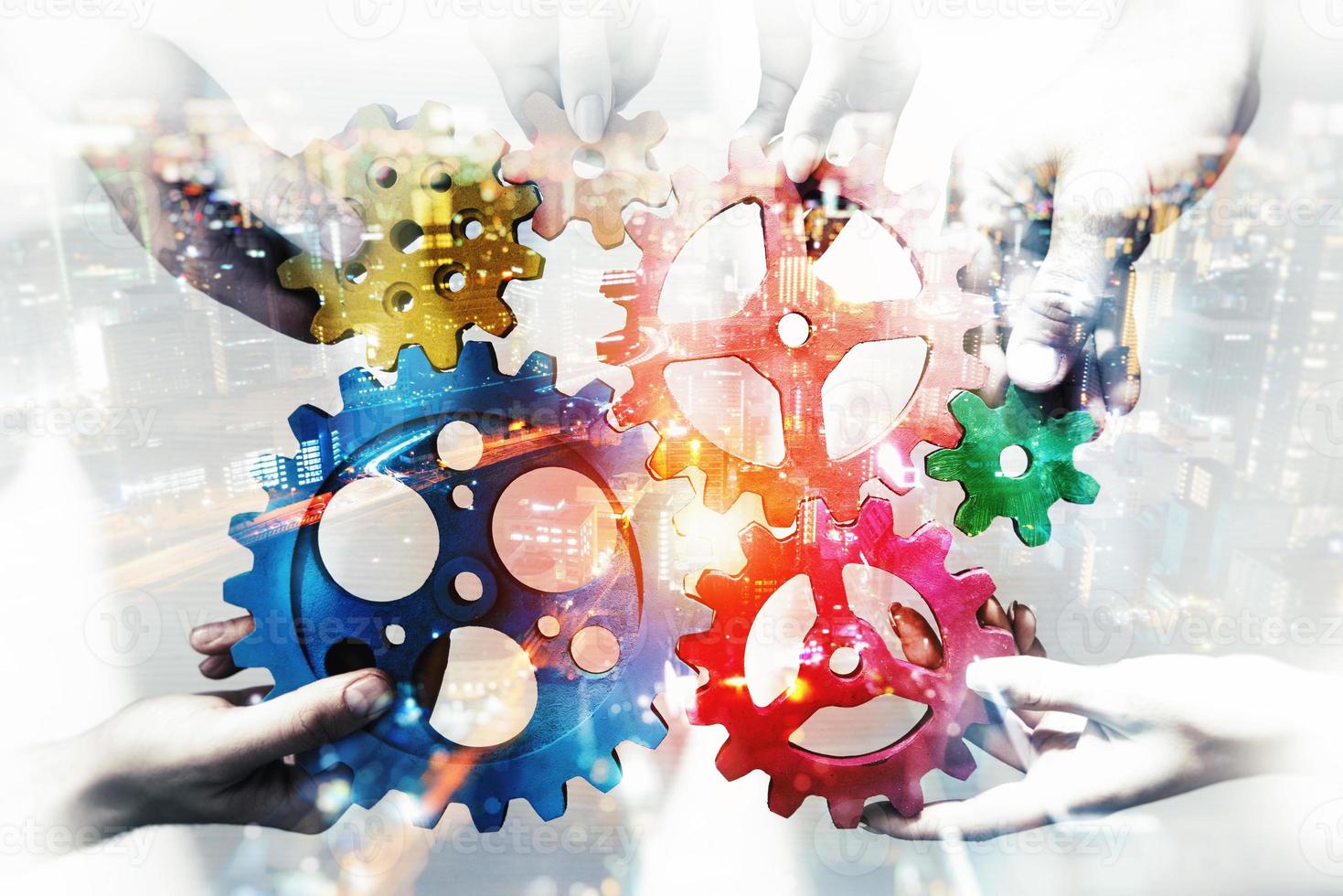 Business team connect pieces of gears. Teamwork, partnership and integration concept. double exposure with light effects photo