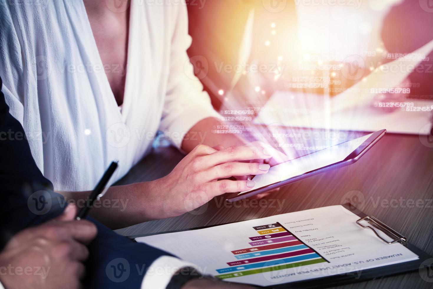 Businessperson in office connected on internet network with tablet. concept of partnership and teamwork photo
