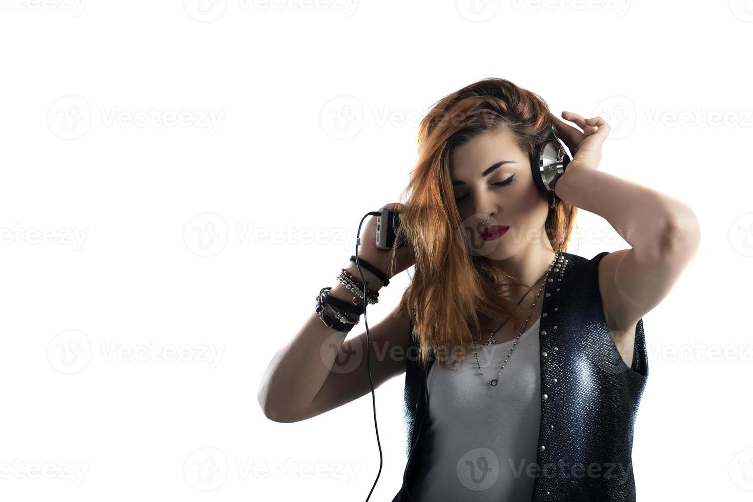 Dancing girl listens to music with headset. isolated on white background photo