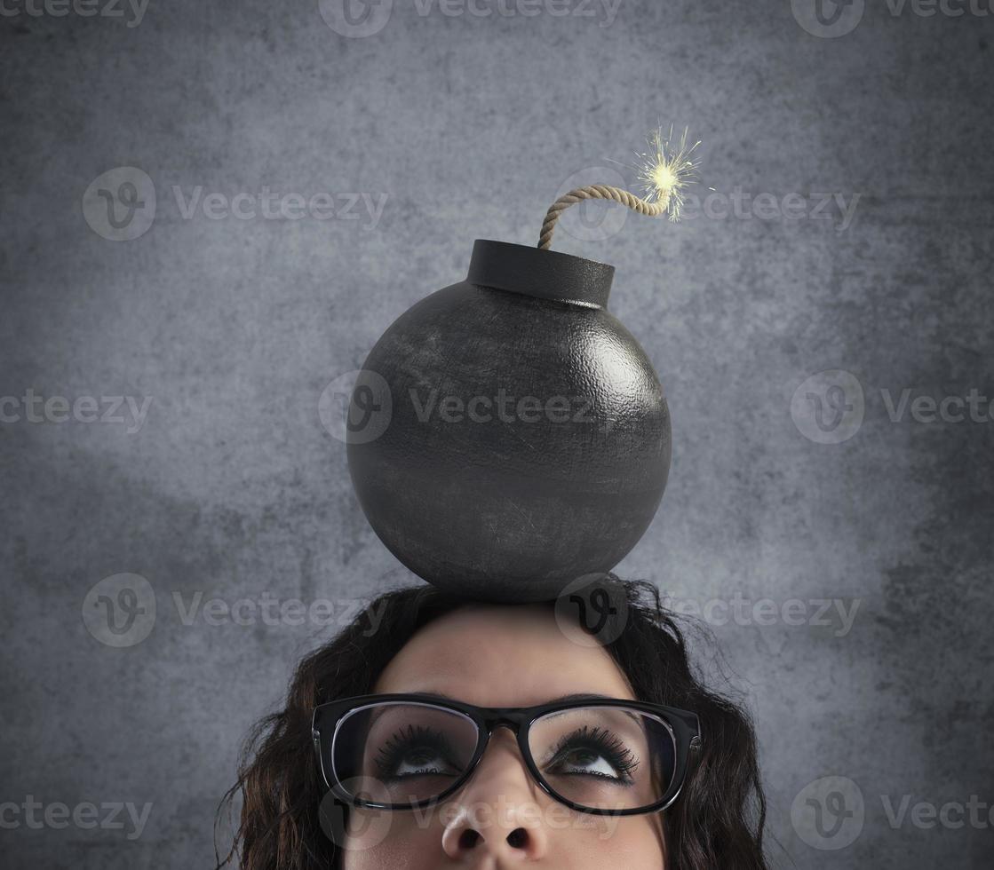 Businesswoman stunned by strong headache with a bomb over the head photo