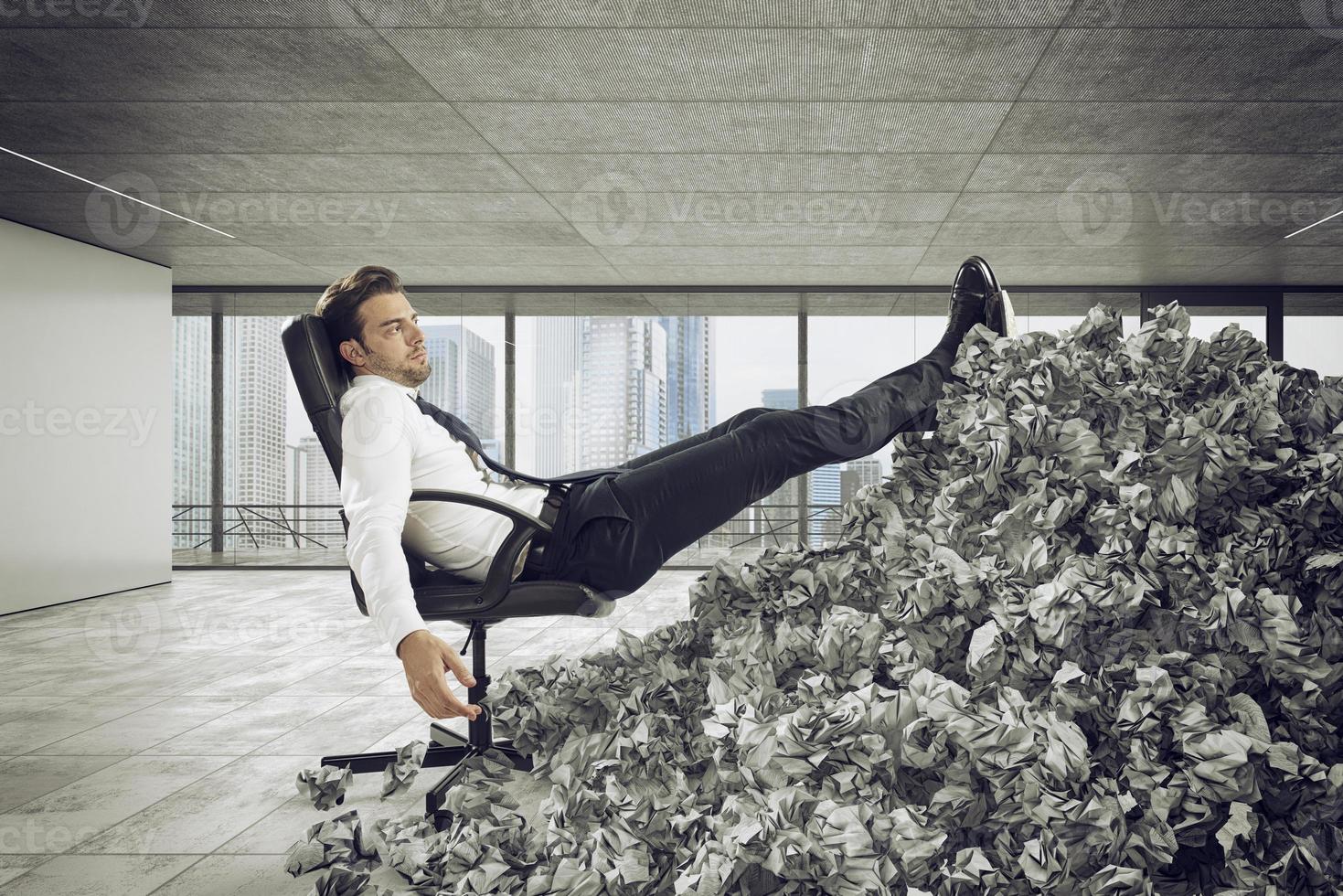 Businessman with paper sheet anywhere. Buried by bureaucracy. Concept of overwork photo