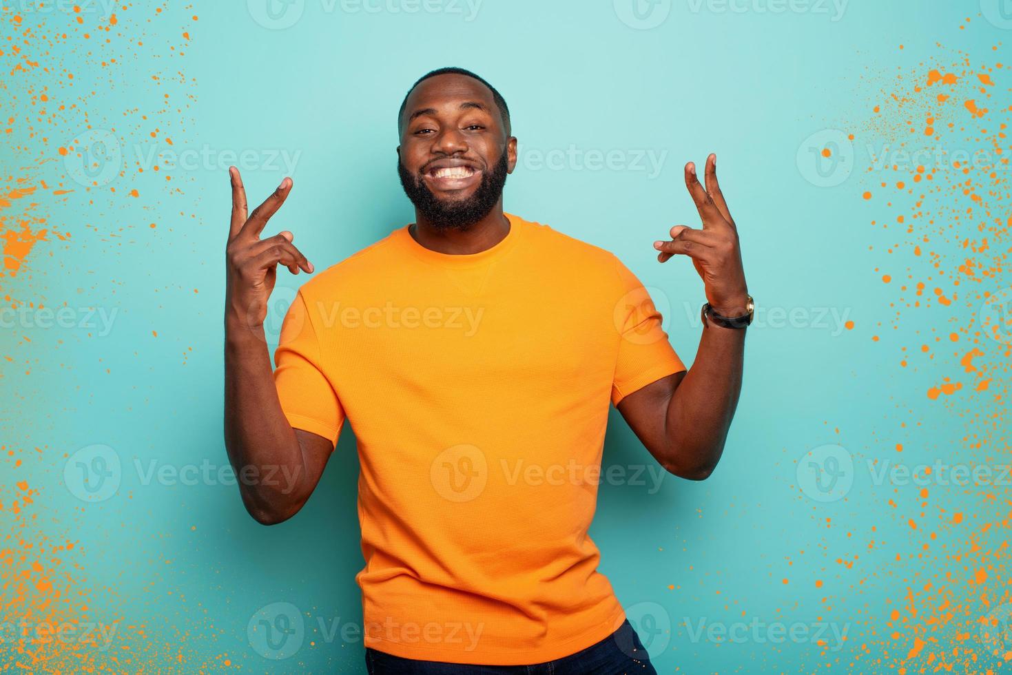 Joyful and happy guy over cyan background photo