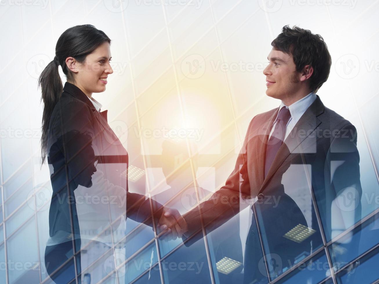 Handshake of two businessperson in office concept of partnership and teamwork.double exposure photo