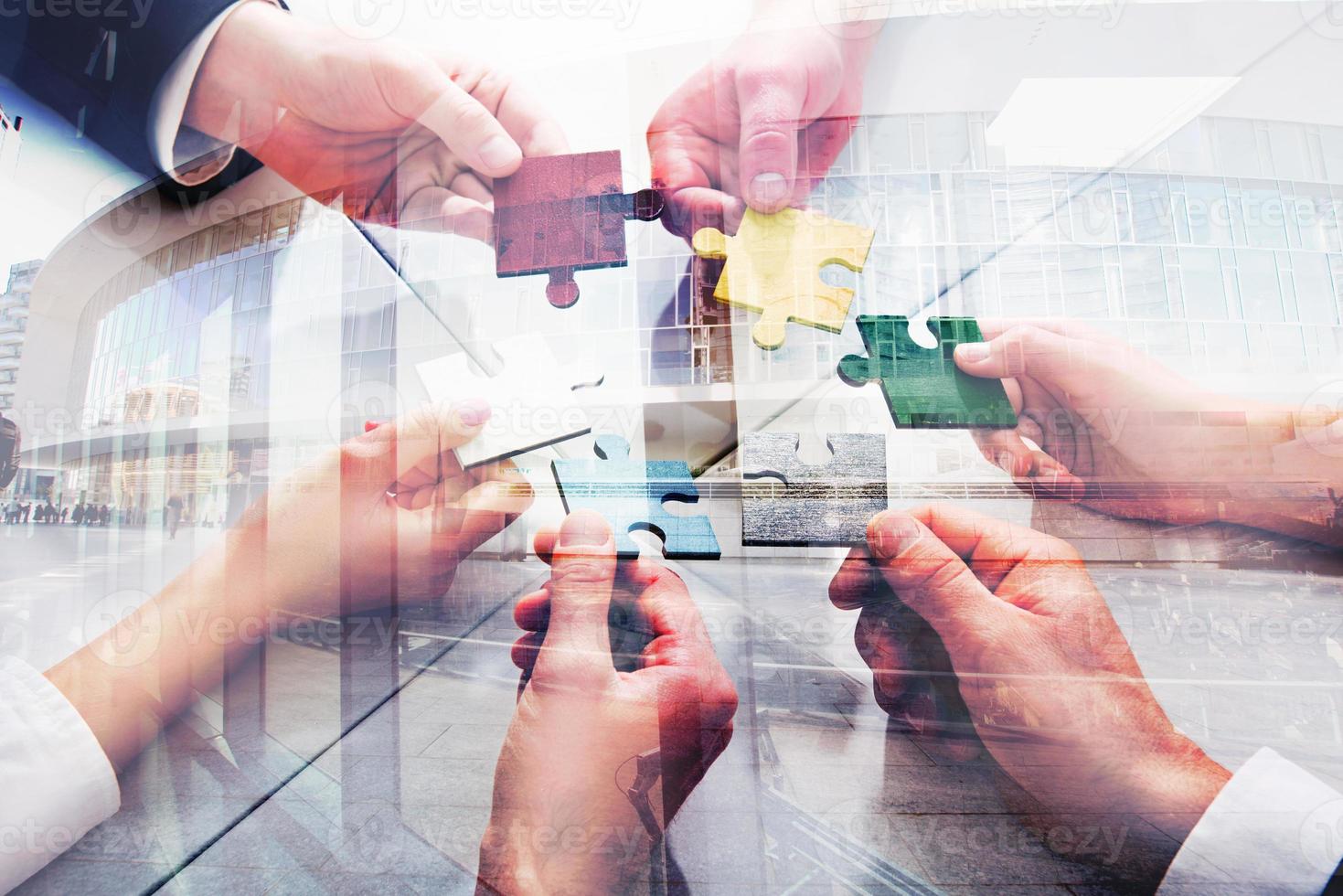 Teamwork of partners. Concept of integration and startup with puzzle pieces. double exposure photo